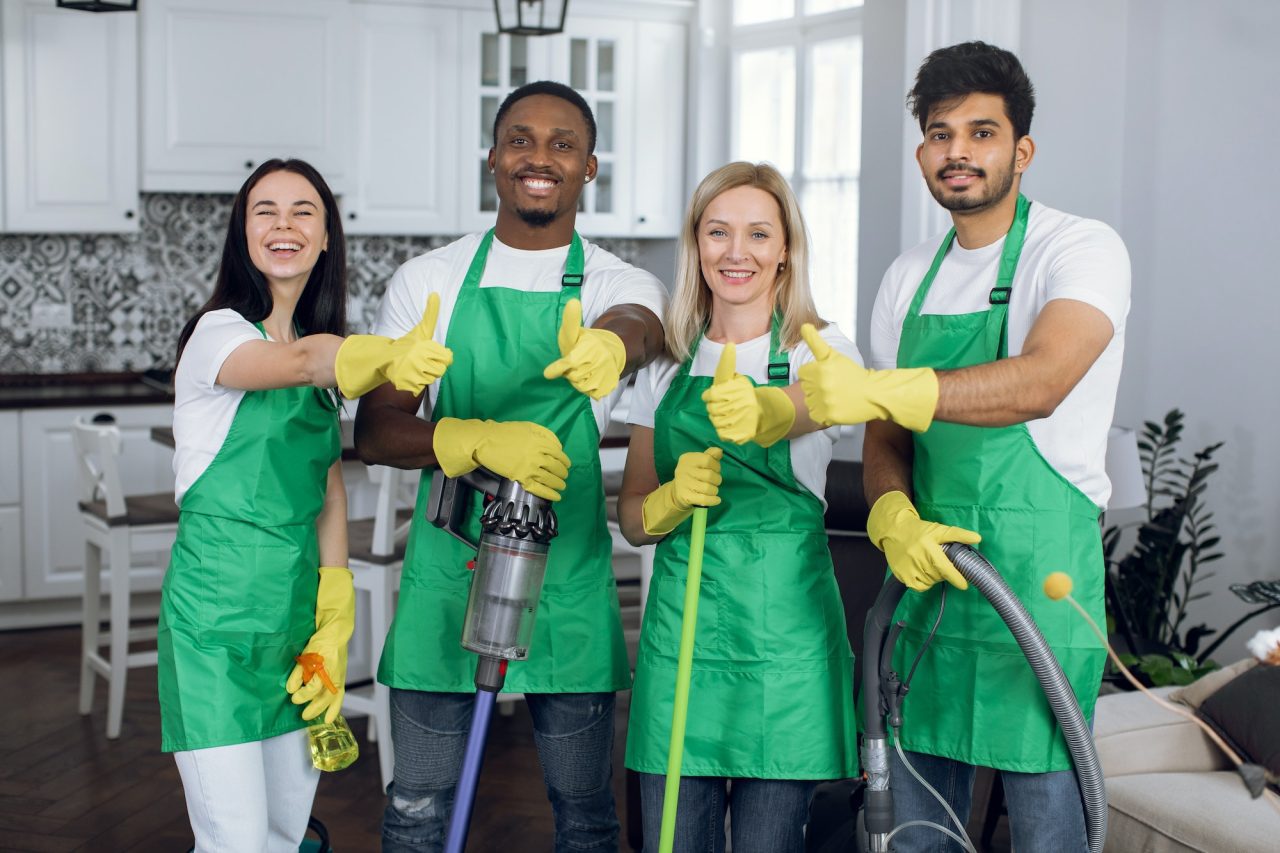 smiling-multiracial-team-of-professional-cleaners-showing-thumbs-up-to-camera.jpg